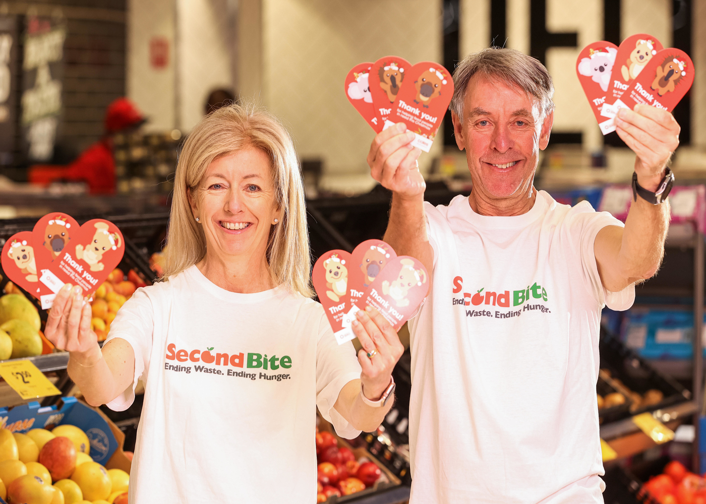 SecondBite co-founders Simone and Ian Carson with the $2 donation cards available at Coles