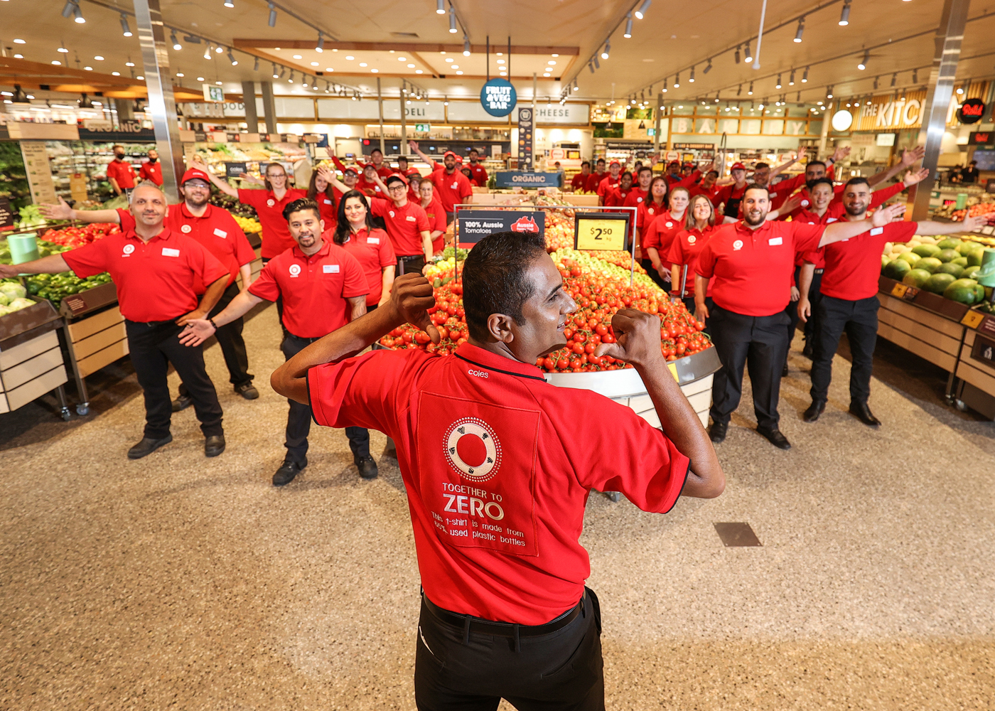 Coles Moonee Ponds team members with Store Manager Vignesh pointing at Together to Zero logo