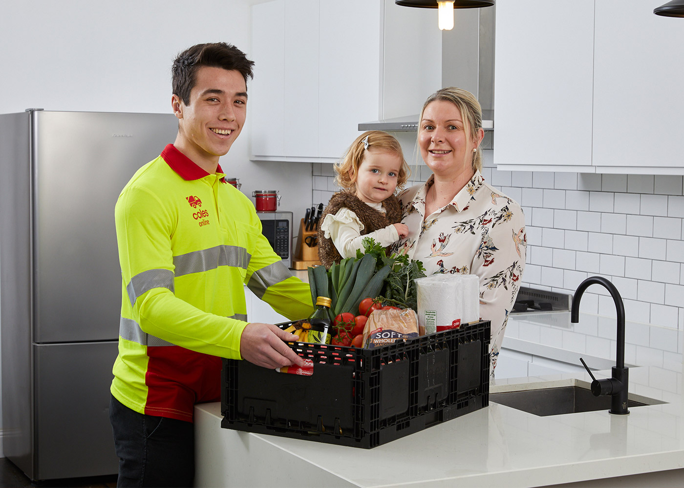 Coles Online team member Tom in customer Bec's kitchen