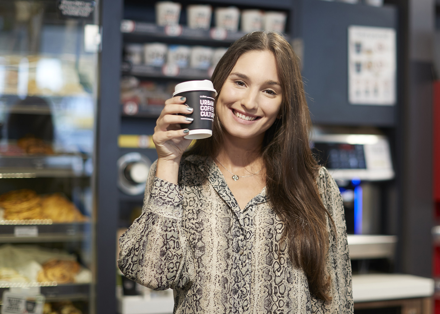 Girl holding Coles Express coffee