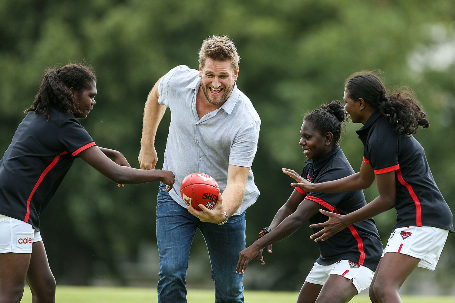 Left to Right: Freda Puruntatameri, Curtis Stone, Jamie-Lee Puautijimi and Aggie Singh playing football