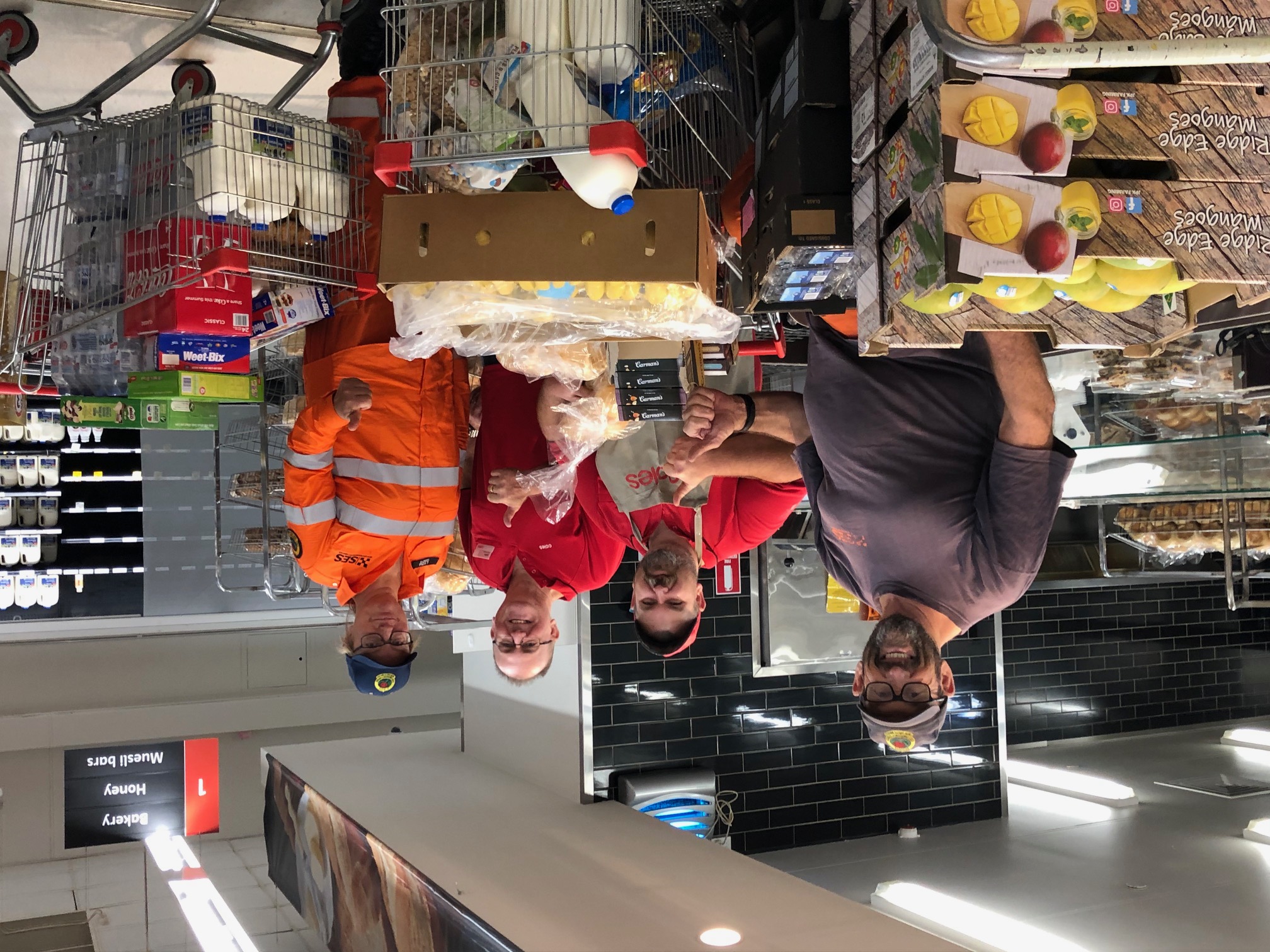 RFS fireys with Coles Batemans Bay team members receiving donations of full trolleys of groceries and fresh produce