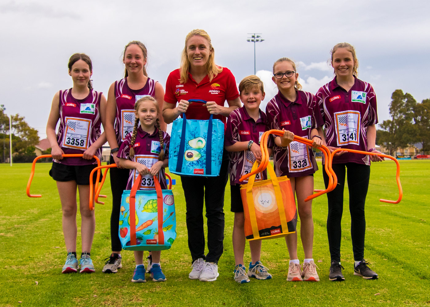 Olympic & World Champion Sally Pearson with athletes from Mid Coast Little Athletics Centre (SA) and their new equipment and the Coles Community Bags